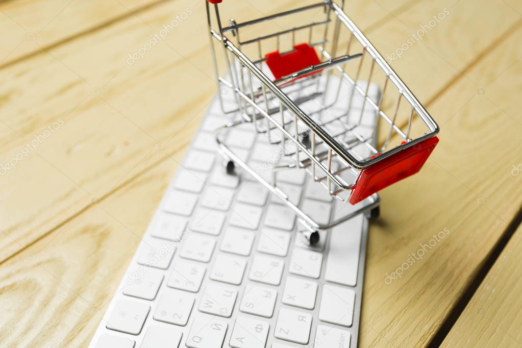 Online shopping concept, shopping cart on keyboard 