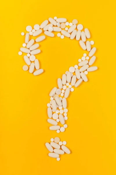 White medical pills on color background