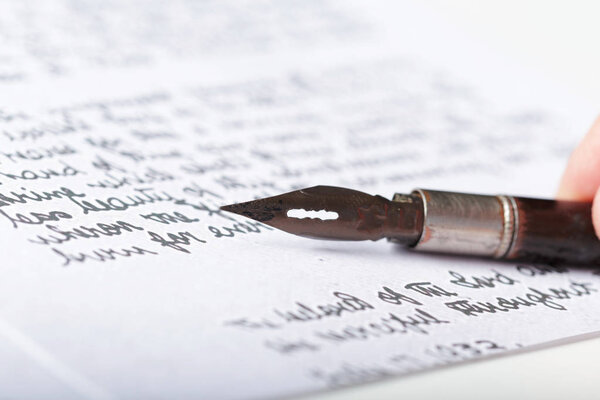 Фонтанная ручка на старинном рукописном письме
