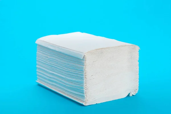 Stack of paper towels on blue