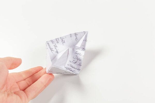 Paper ship in a female hand