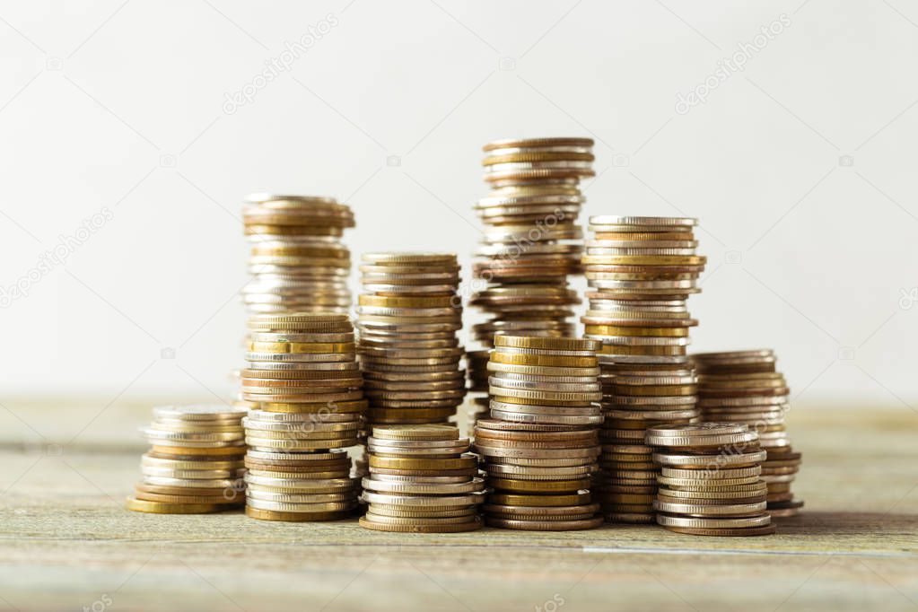 coins stack on wooden table