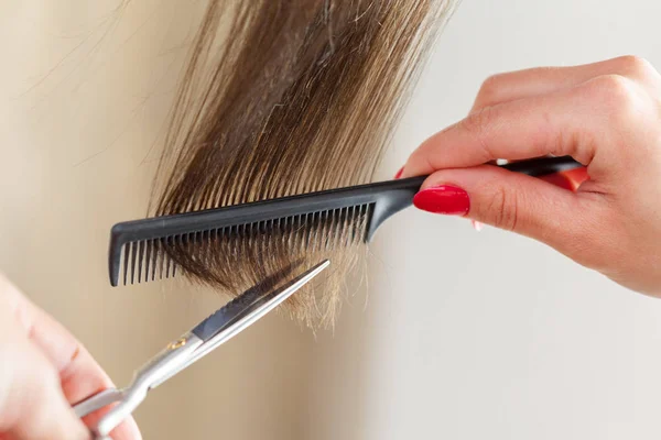 Close view of Woman doing haircut in salon