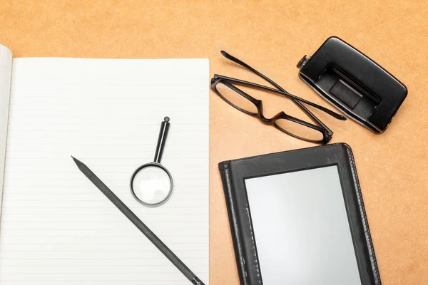 work desk with glasses and magnifying glass