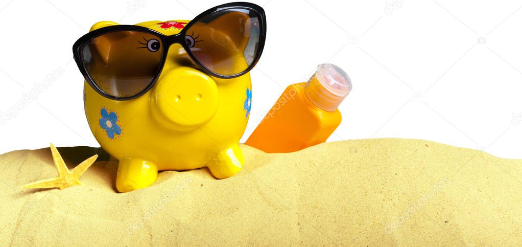Summer piggy bank with sunglasses on beach