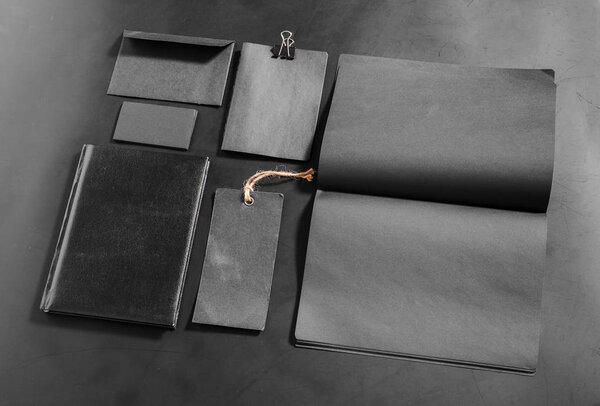 Черные пустые канцелярские принадлежности на черном фоне
