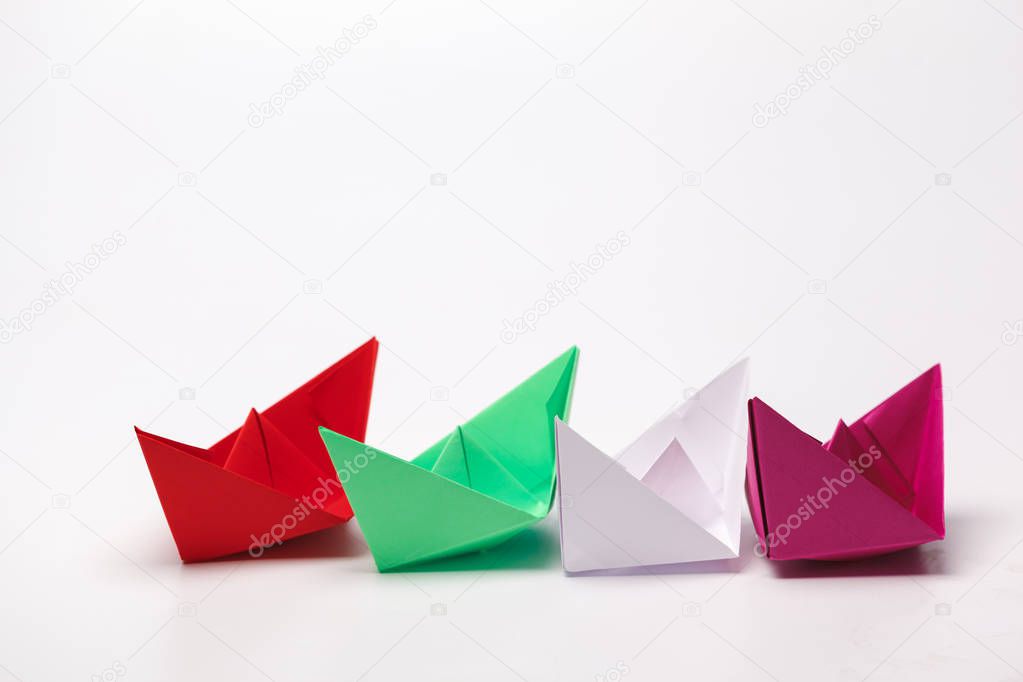 Set of origami paper boats. Leadership and business concept