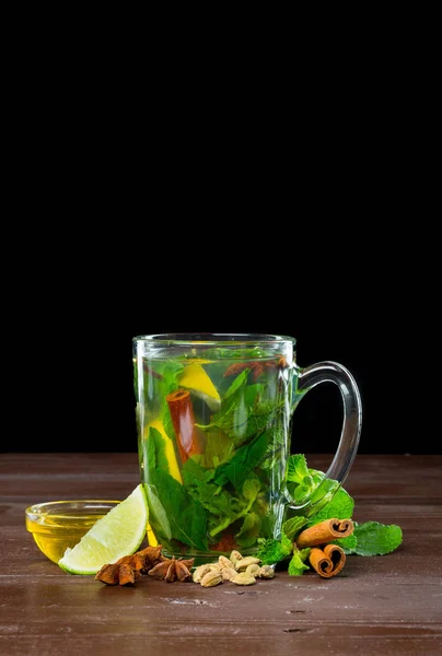 Glass of green tea with lime, lemon, mint