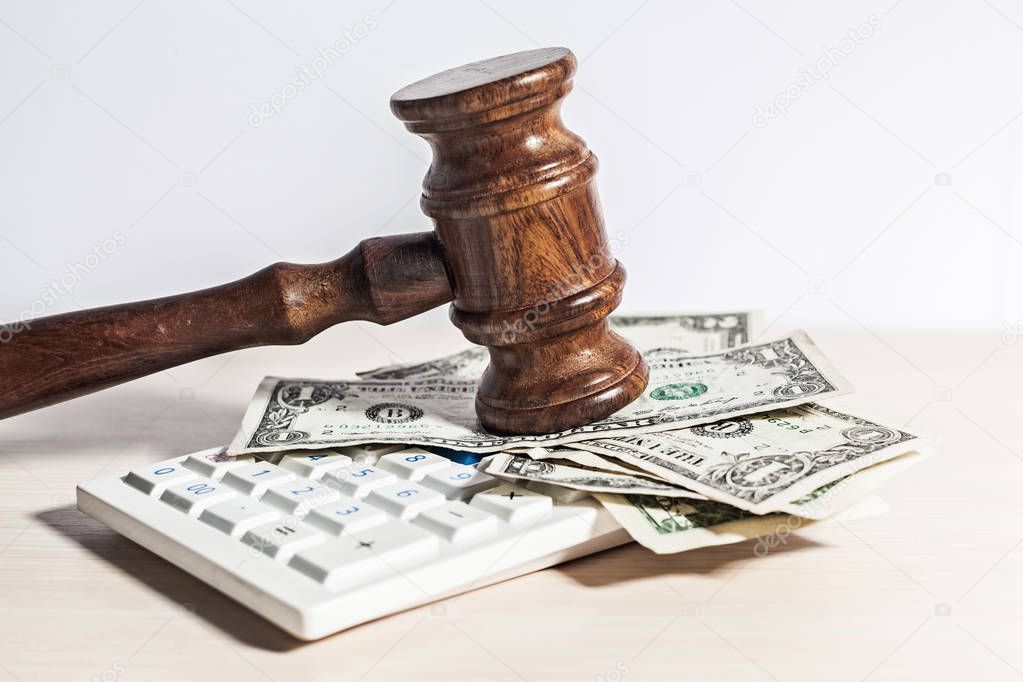 judge gavel and money on wooden table