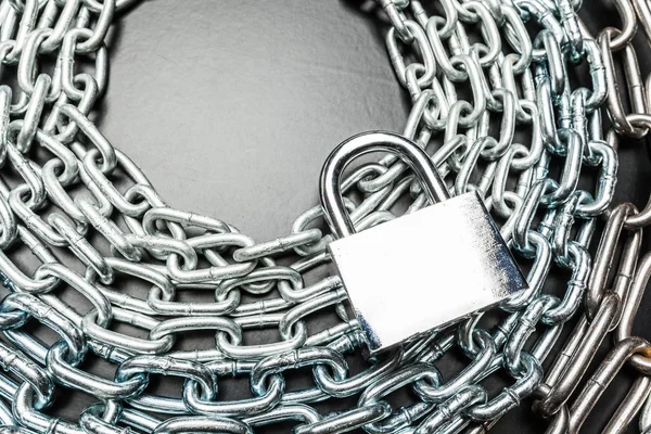 metal chain and padlock on metal background