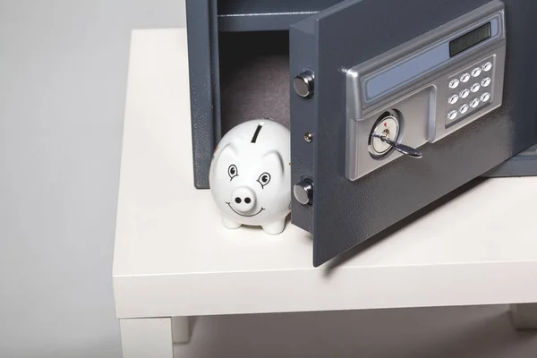 white piggy bank in safe with buttons