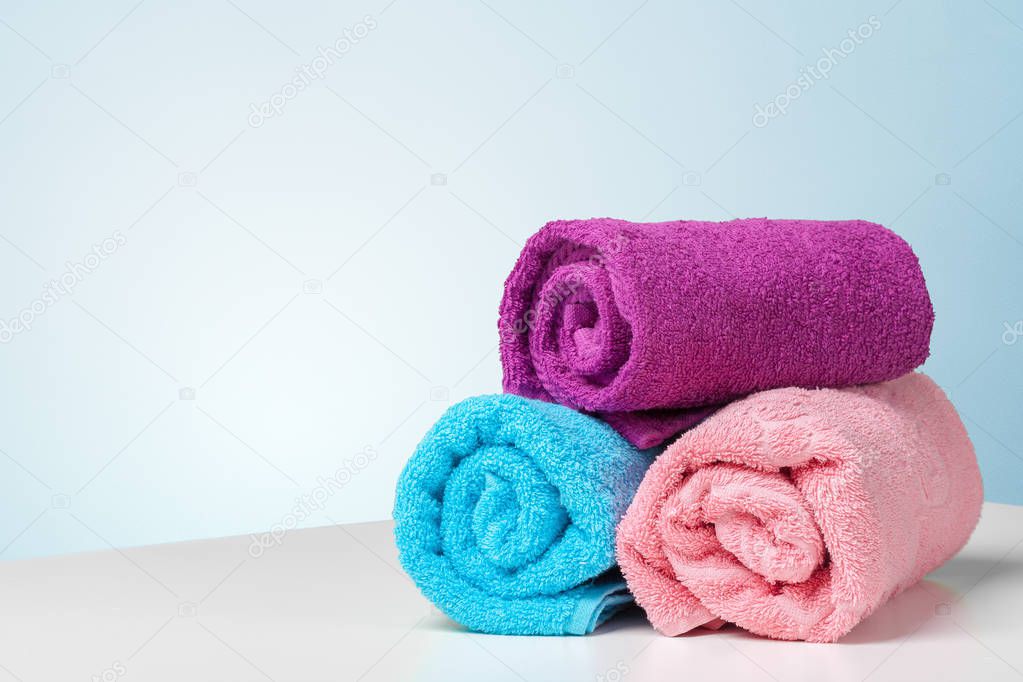 Stack of bath towels on white desk 