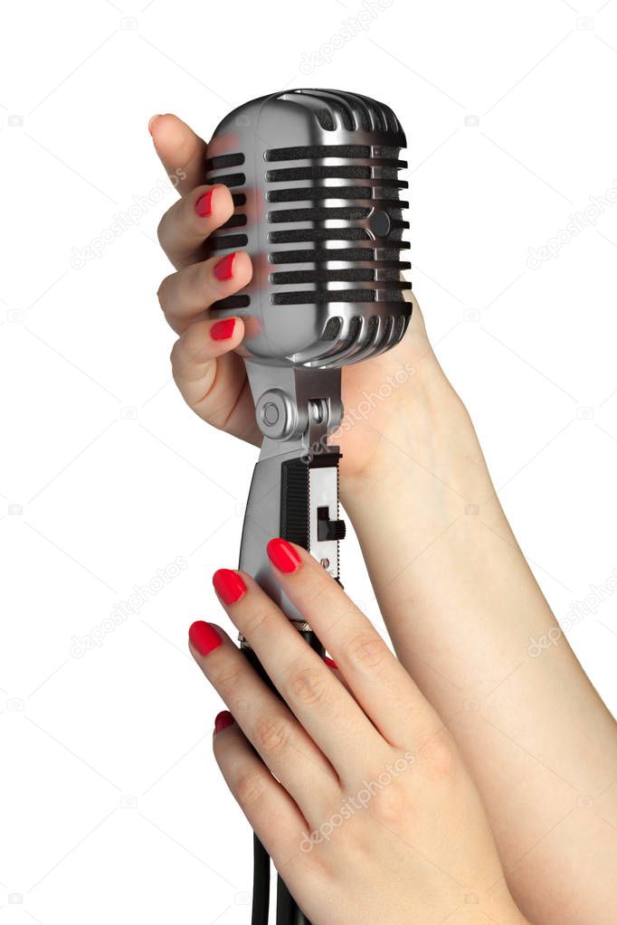 female hands on audio microphone in retro style