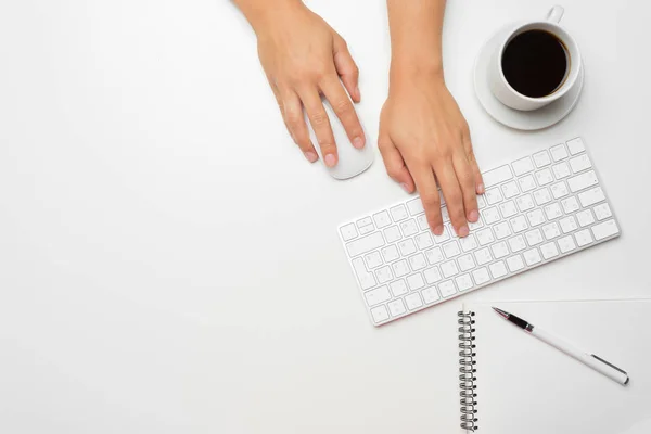 women\'s hands using keyboard and mouse