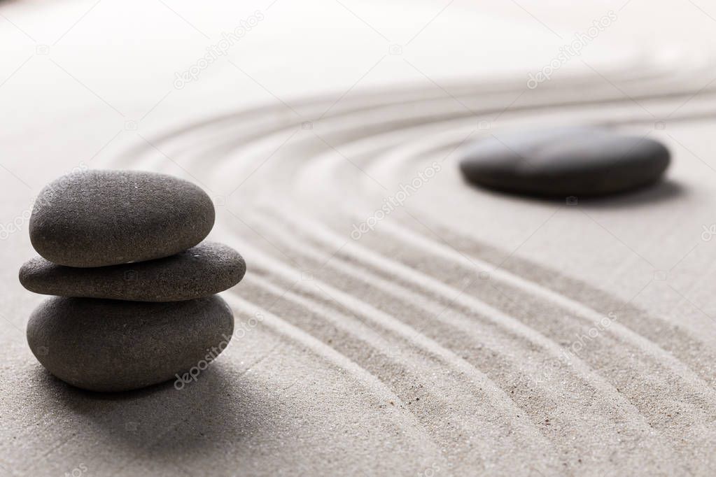 zen stone garden round stone and raked sand 