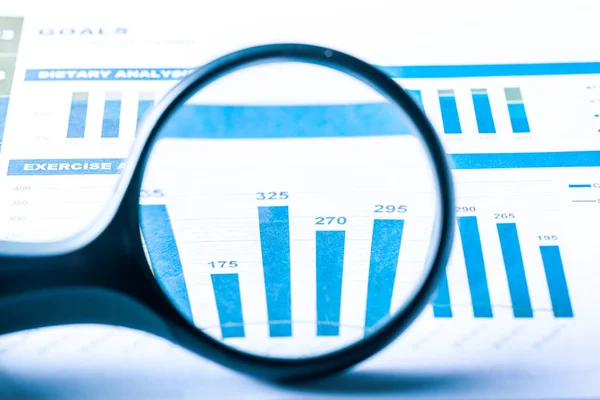 Magnifying glass and business growth graph