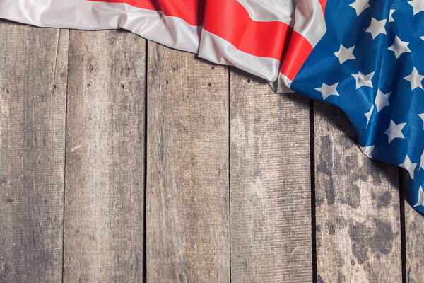 American flag lying on rustic wooden background