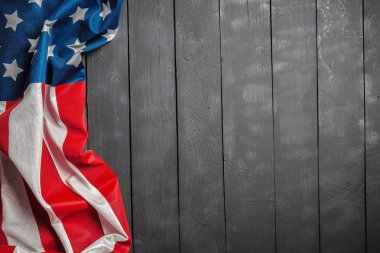 American flag lying on rustic wooden background clipart