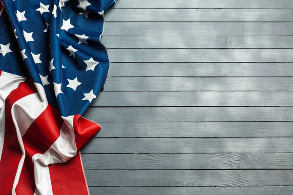 American flag lying on rustic wooden background