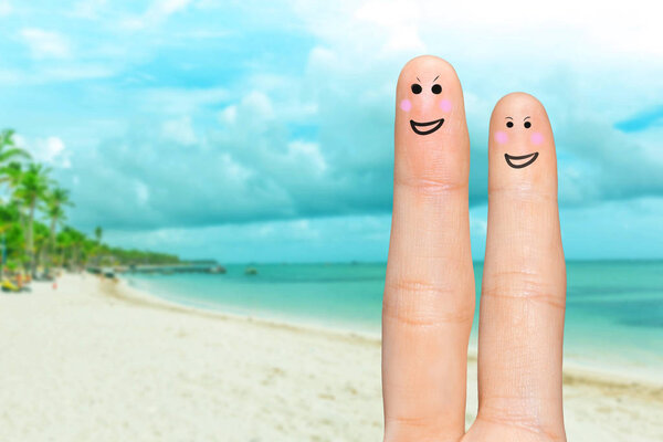 Human hand fingers with funny painted emoticons. People relationships concept