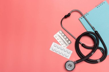 Pastel pembe bir arka plan üzerinde tıbbi donatımı.