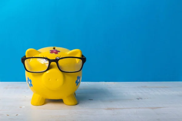 Yellow piggy bank  on blue background