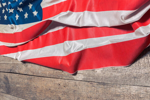 American flag lying on rustic wooden background