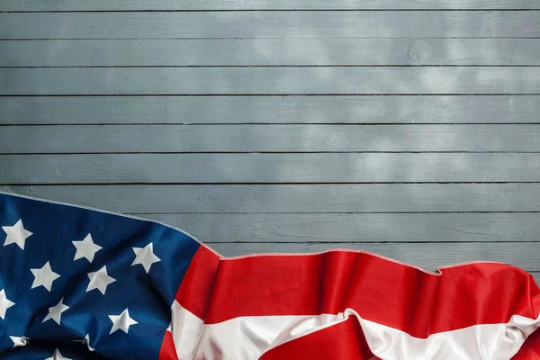 American flag lying on rustic wooden background