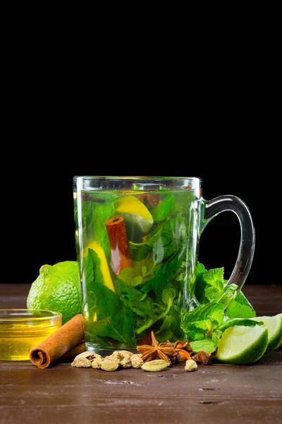 Glass of green tea with lime, lemon, mint