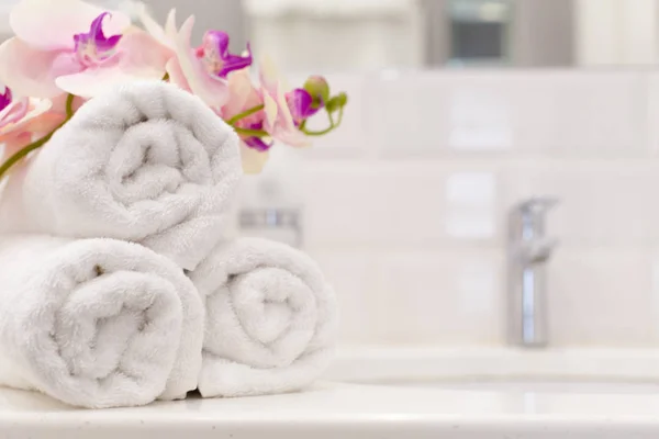 Stack of towels with flower decor in a hotel room