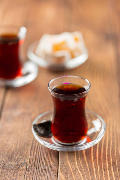 Red tea in turkish glasses on a wooden table