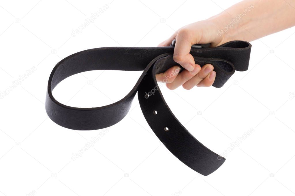 Hand holding leather belt for punishment on white background