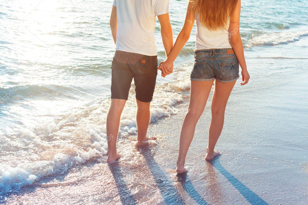 couple walking on the beach at summer 