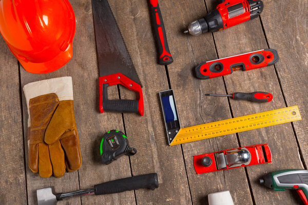 Assorted work tools on wood background