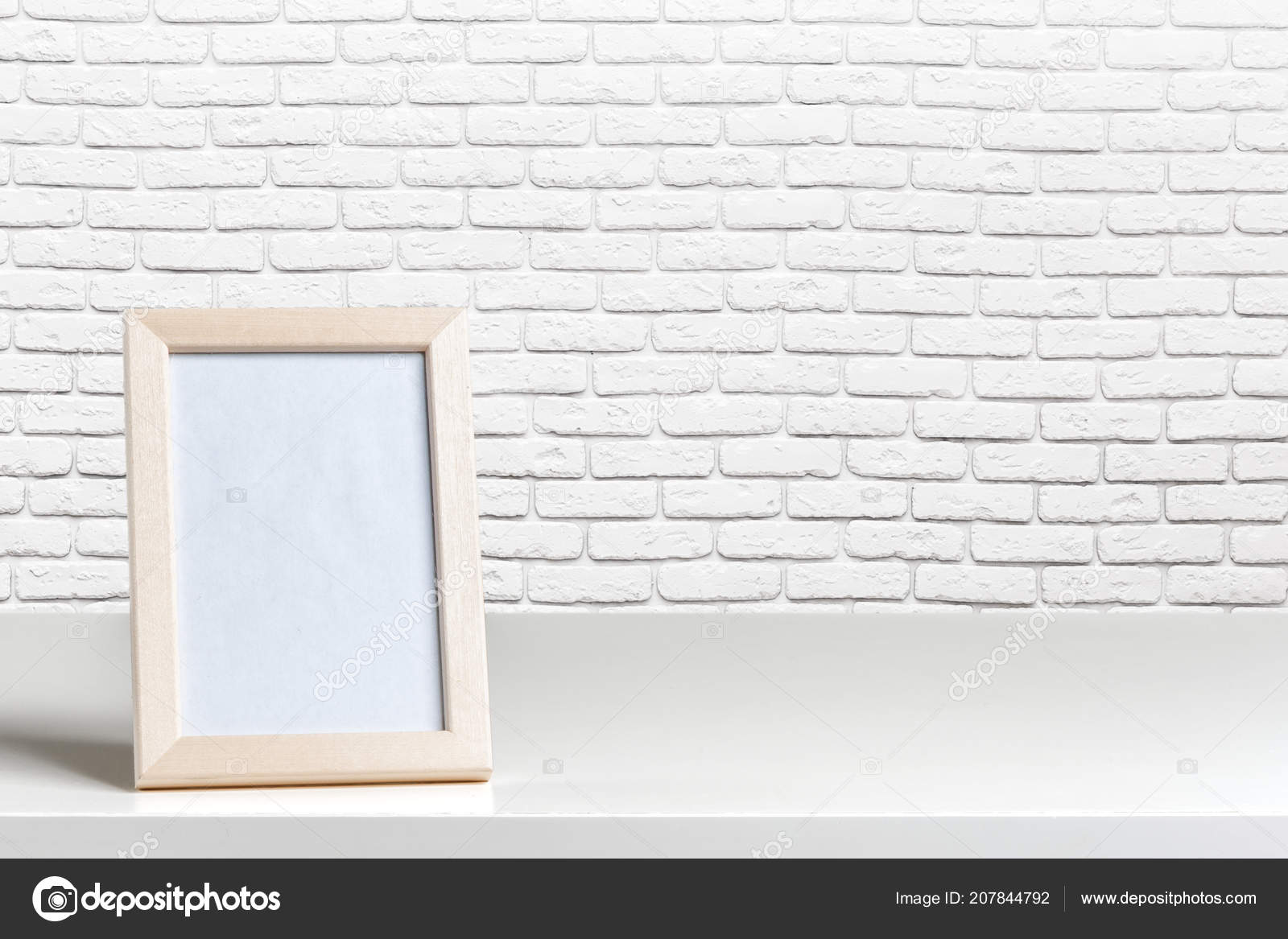 Blank White Picture Frame Wall Table Wood Stock Photo by ©Fotofabrika