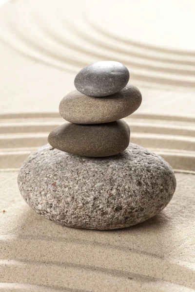 zen meditation stones on sandy background