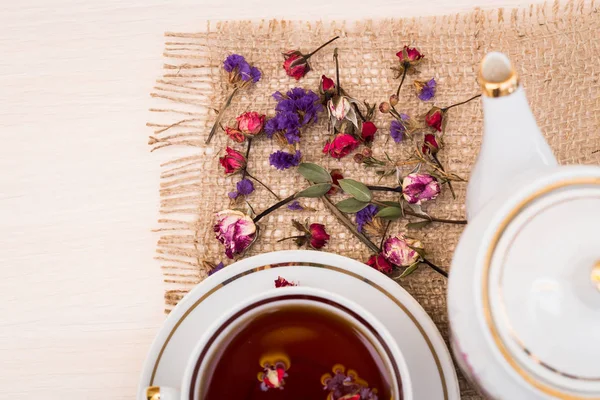 Vintage cup of tea with buds of roses