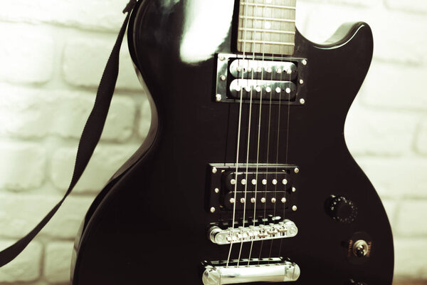 Electric guitar body and neck detail on wooden background