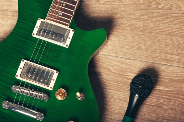 Electric guitar body and neck detail on wooden background