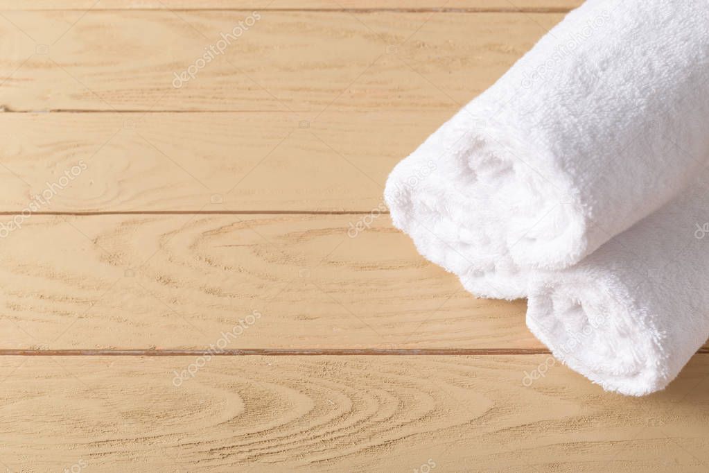 spa towels on wooden surface