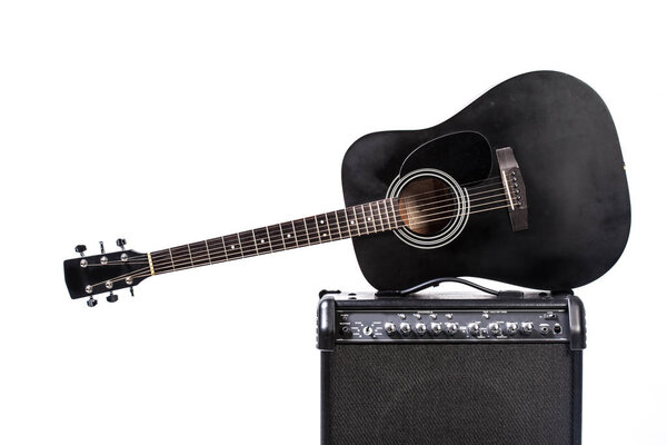 Close up of Black acoustic guitar on white background