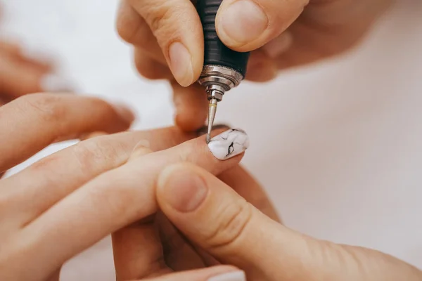 Manicurist with a milling cutter for manicure