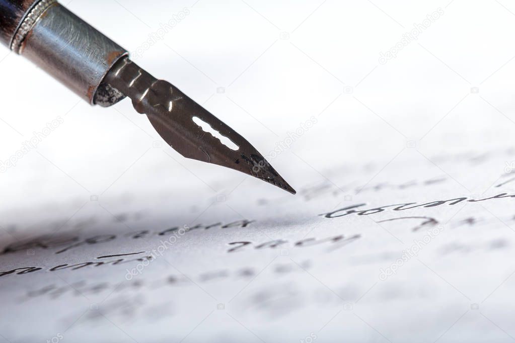 Fountain pen on antique handwritten letter, close-up 