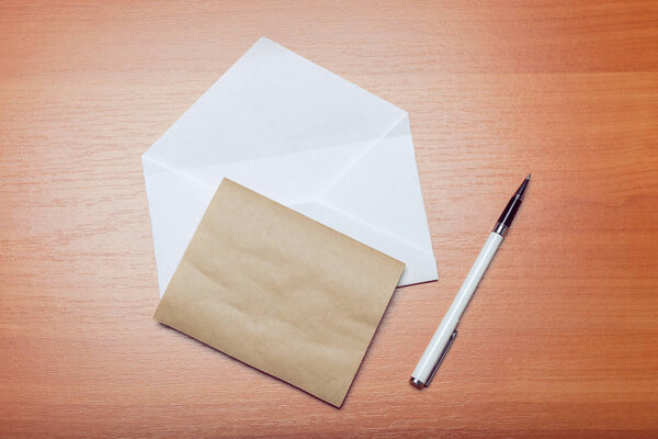 Photo of blank envelope on wooden background