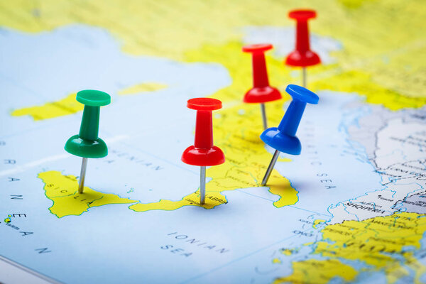 Travel destination points on a map indicated with colorful thumbtacks
