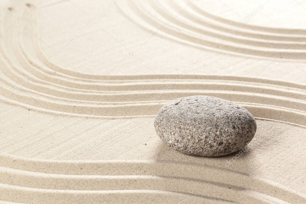 Japanese garden zen stone on sand