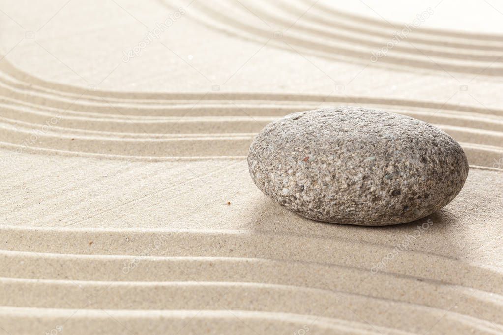 Japanese garden zen stone on sand