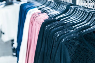 Askılarda farklı giysiler. Kapatın.