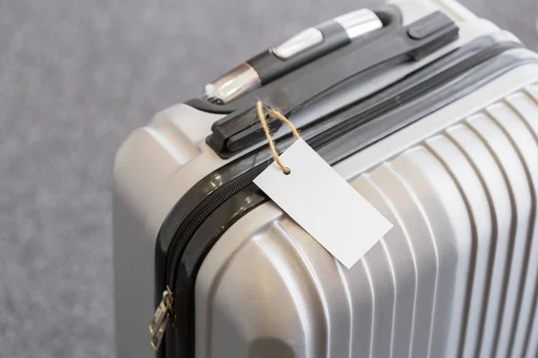 Close up of blank  luggage tag label on a suitcase