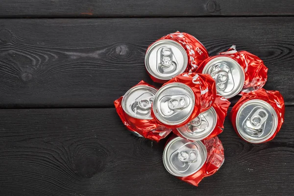 compressed aluminum cans on wooden background